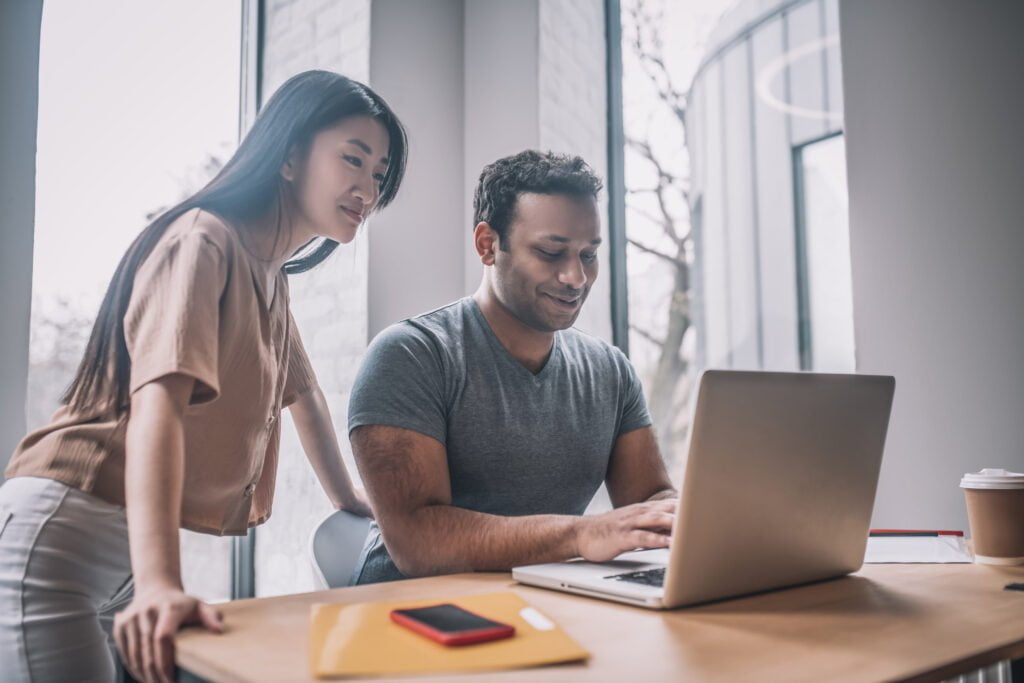 dark skinned guy at laptop and asian girl watching 2022 01 19 00 09 05 utc